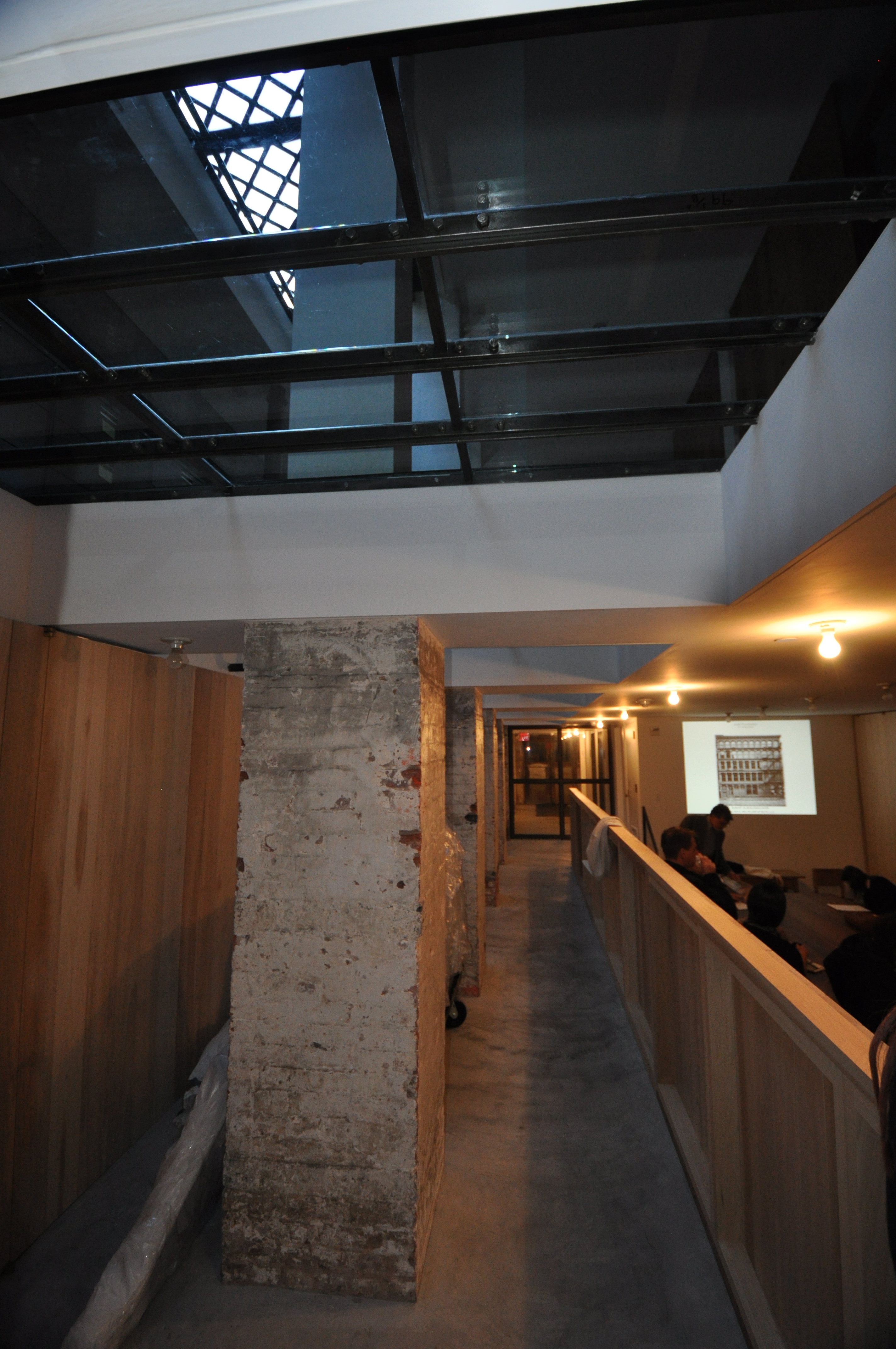 Figure 6:  The future-proof restoration of a cast iron facade building in the Garment District of New York, NY.  This renovation restored the building’s capacity to bring light to the lowest levels of the basement through glazed sidewalk vault panels (top left) and has helped to ensure the ongoing use and occupancy of the building.  (Brian Rich, 2013)